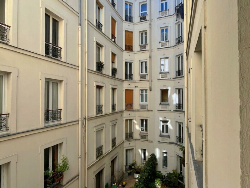Façades sur cour d'un immeuble haussmannien, balcons en fer forgé et verdure, 92 rue du Mont-Cenis Paris, par Rethink